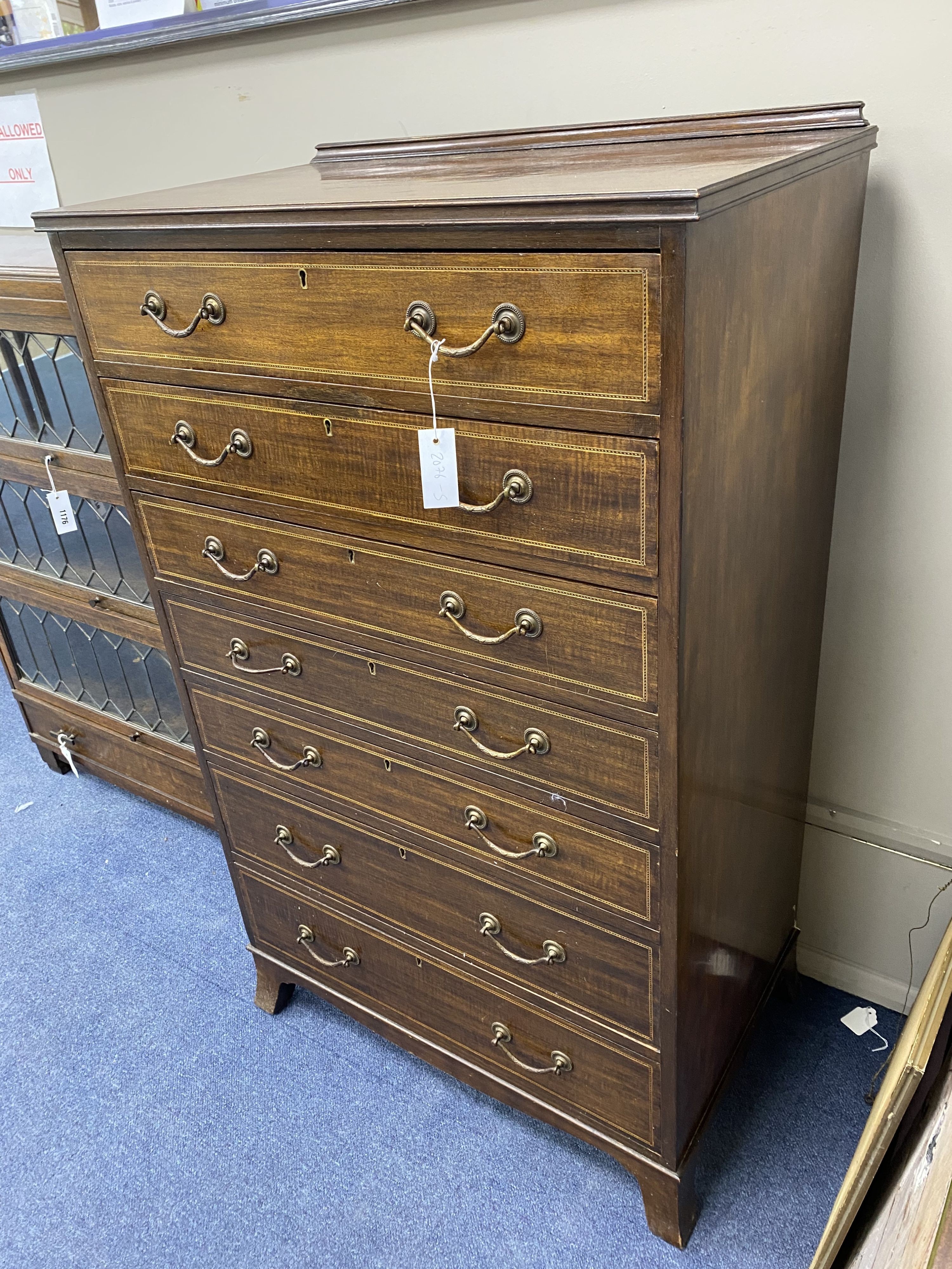 An Edwardian mahogany seven drawer chest, width 73cm, depth 44cm, height 122cm